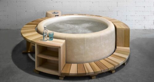 A bright softub filled with water with a light wooden border with side cabinets