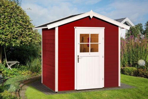 Small, red garden house with a small white door and a saddle roof, standing on a green lawn.