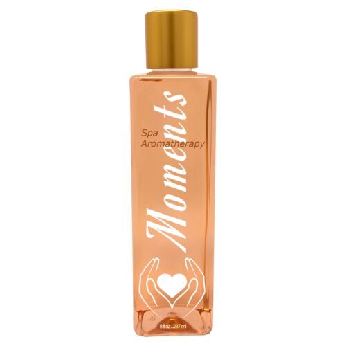 A pink, orange bottle with a golden lid and white writing that spells moments