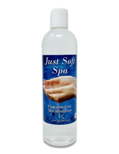A white bottle with a blue label. Just Soft Spa is written in white writing on the blue lable. An Image of two hands can also be seen.