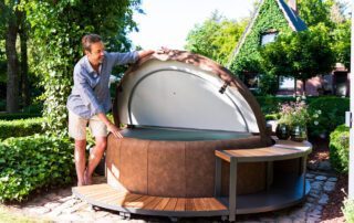 Man open the cover of his Softub for water care