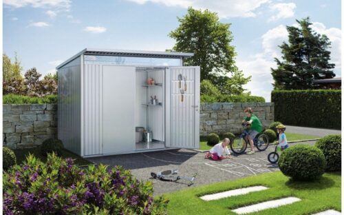 The biohort Garden Shed AvantGarde. The metallic Garden Shed is standing in a garden. The single door is open. In the garden are several trees and a few kids that are playing with their bicycles.